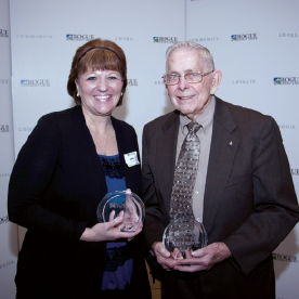 Two RCU employees holding awards